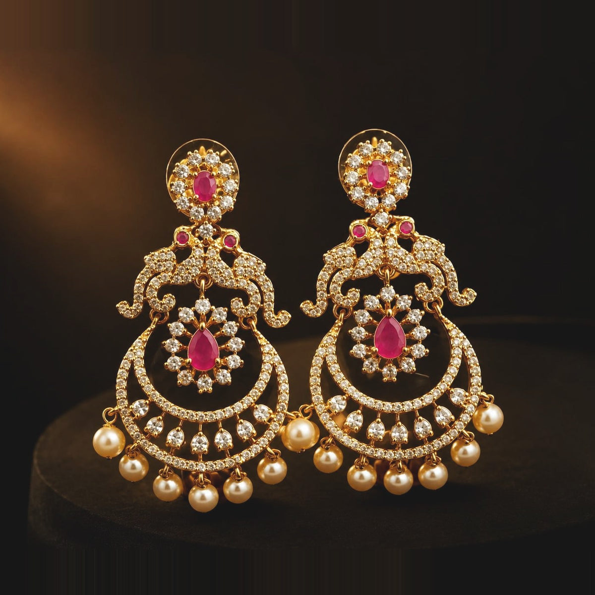 Ruby-toned chandbali earrings with clear-stone crescent and pearl-style drops