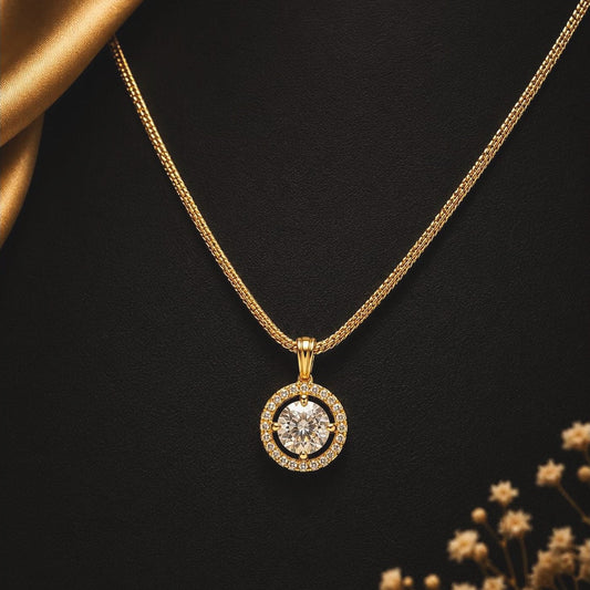 Clear-stone centre pendant framed by a stone halo on a fine gold-toned chain, front view