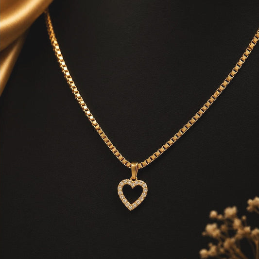 Gold-toned box chain with a clear-stone heart pendant, front view