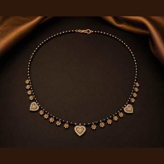 Black bead mangalsutra with clear-stone heart motifs and star accents, front view