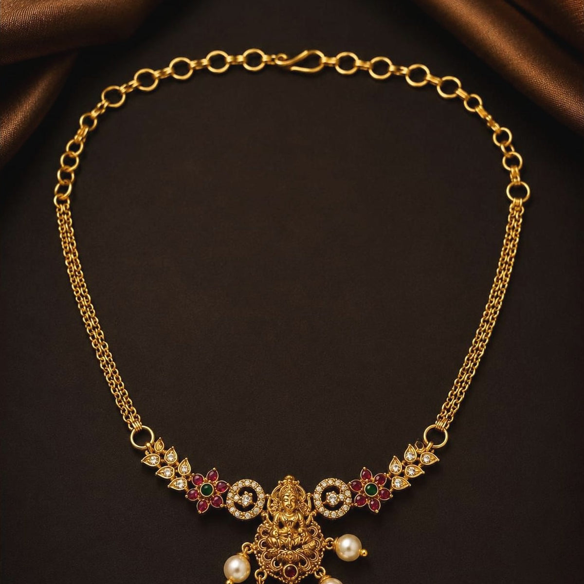Temple choker with a Lakshmi centrepiece, ruby-toned and emerald-toned accents and pearl-style drops, front view
