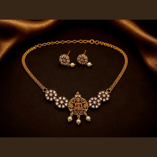 Temple necklace set with a Lakshmi centrepiece, clear-stone clusters and matching earrings, front view
