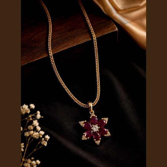 Gold-toned chain with a ruby-toned and clear-stone floral pendant, front view